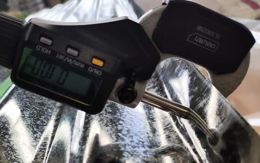 Measuring thickness of corrugated sheet